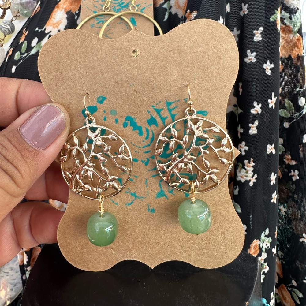 Green jade drops on a gold botanical disc earrings